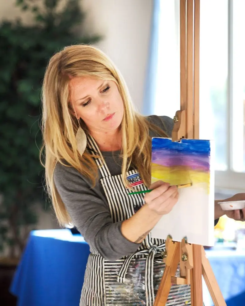 Lu Monteleone painting on a canvas